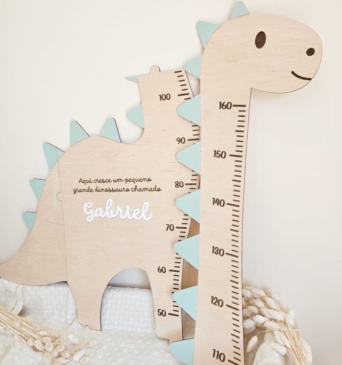 Wooden dinosaur-shaped growth chart with measurement scale and the name Gabriel; a cute baby height ruler in pastel colors, likely for a child’s room.